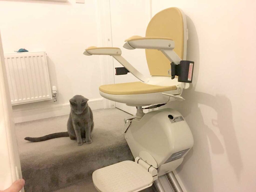 Straight stairlift parked at the foot of the stairs in a London home